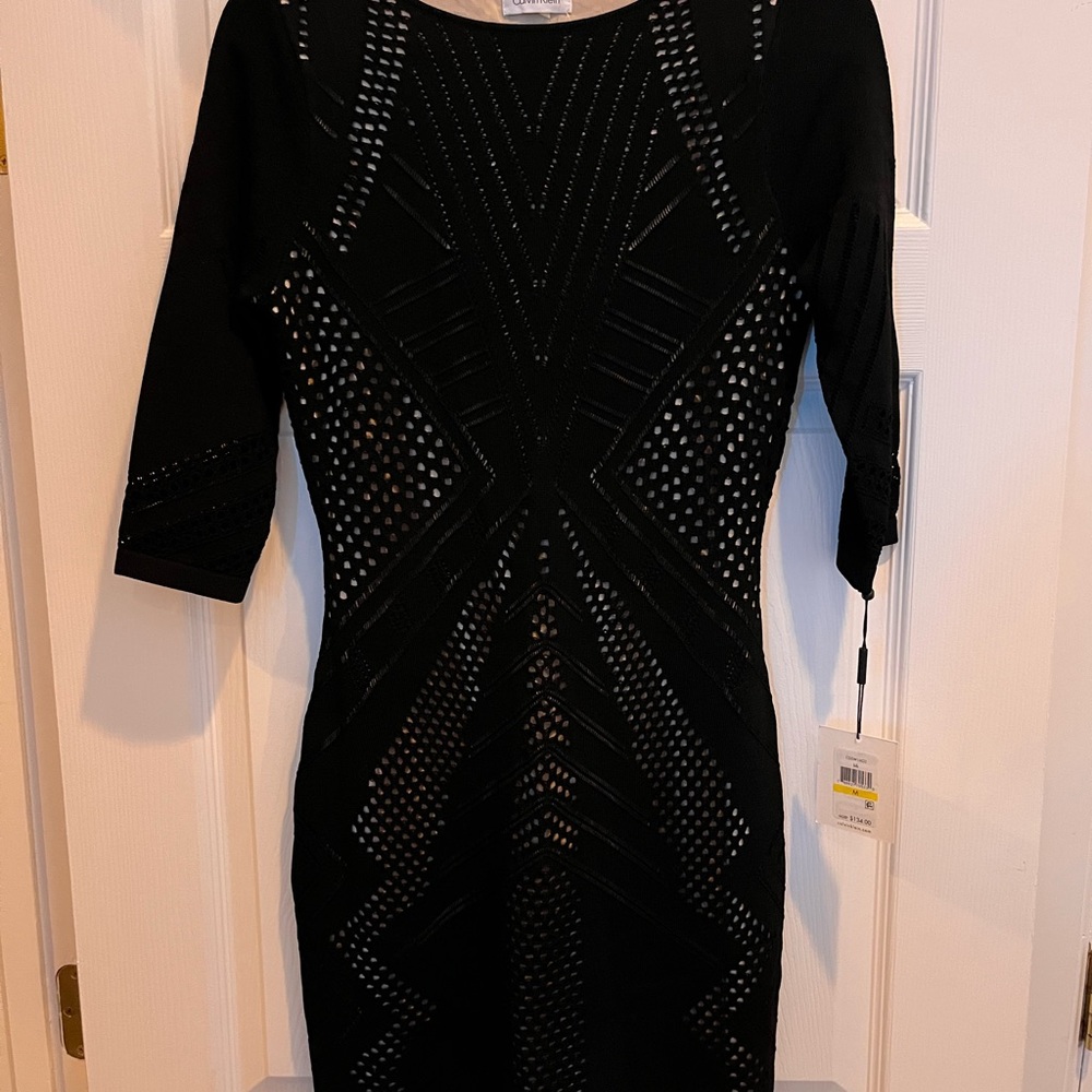 Stunning form fitting black dress with tan underlay details from Calvin Klein